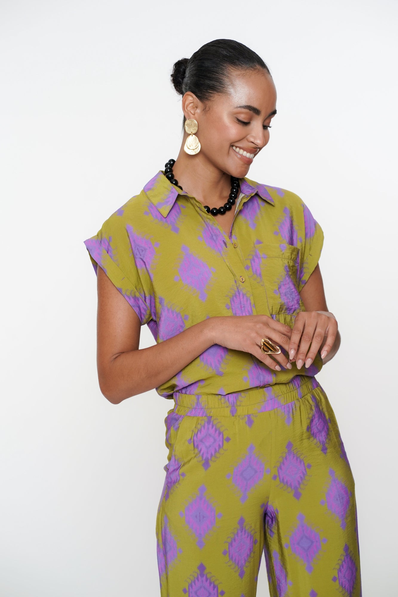 Geisha Fashion shirt, buttoned with geometric patterns, against white.

