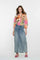 Geisha Fashion: Model wears floral blouse, denim skirt, pink heels.
